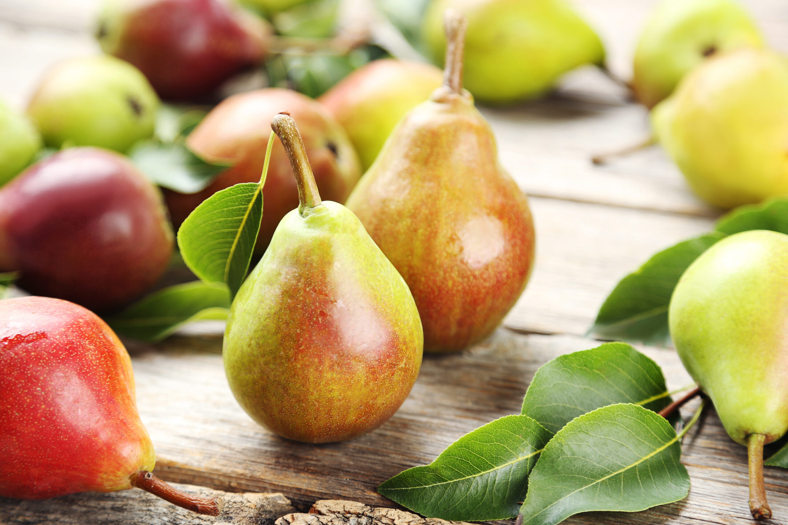 Ripe pears on grey wooden table