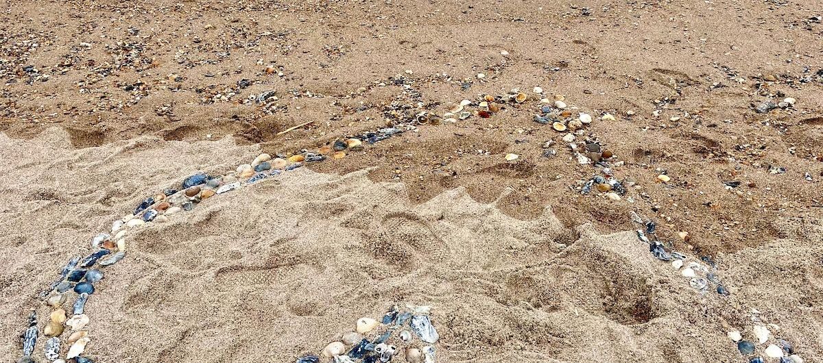 heart made of rocks on beach