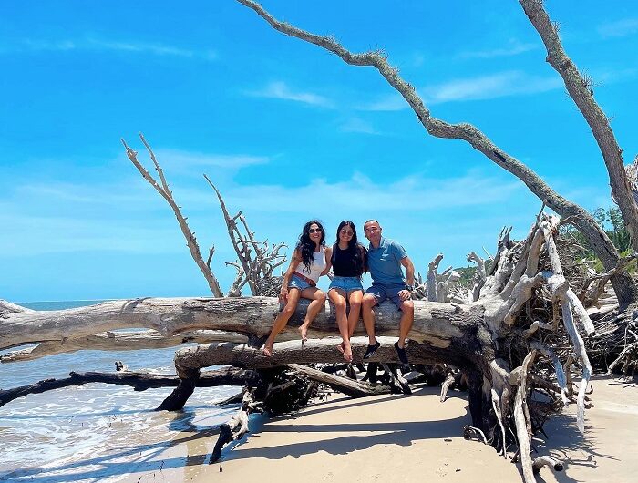 family posing on log